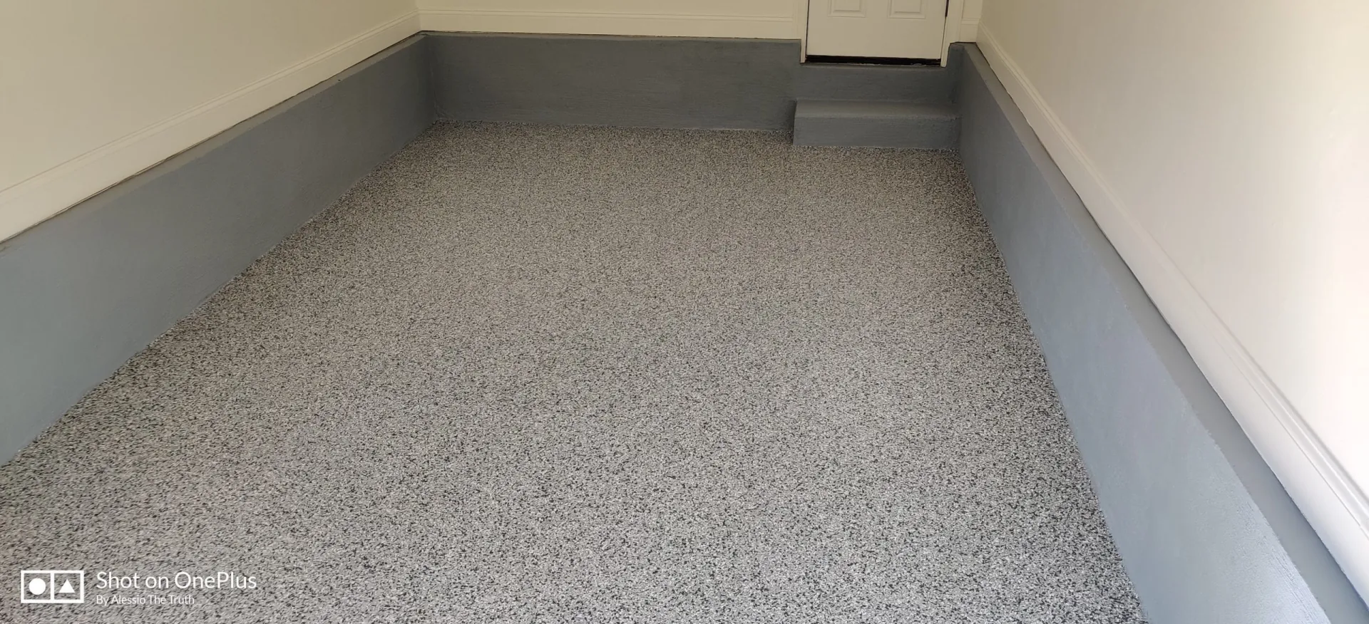 Completed garage floor coating with stem wall