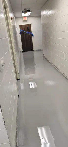 Corridor epoxy floor coating by The Concrete Makeover