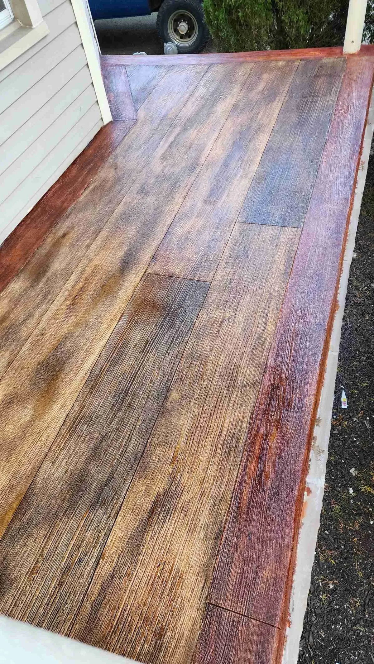 Multi-tone stained concrete wood plank porch by The Concrete Makeover
