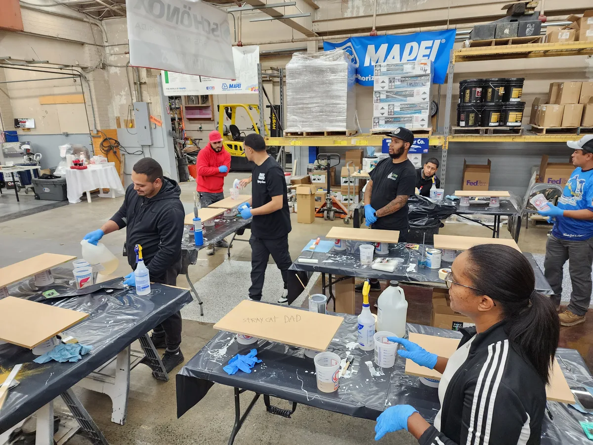 Students working hands-on with epoxy and overlay materials during class