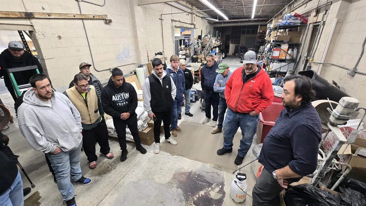 Alessio instructing a group of contractors on concrete techniques