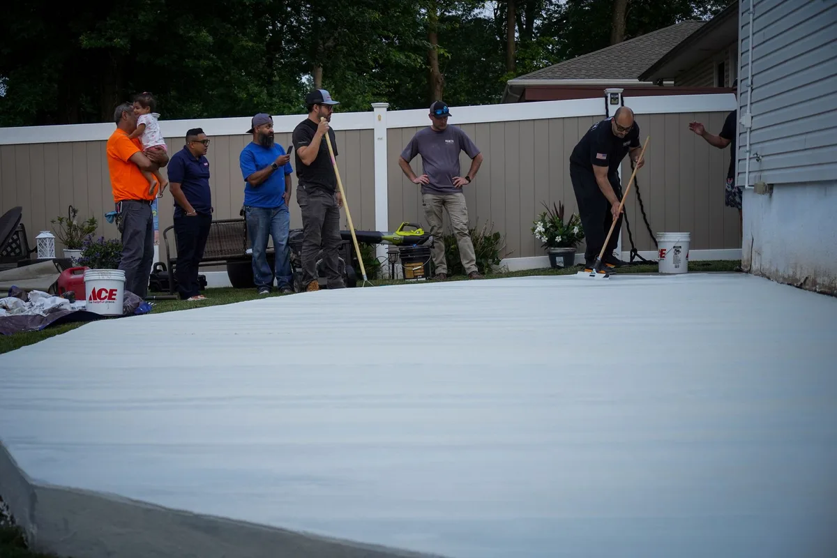 Hands-on outdoor concrete overlay application during training class
