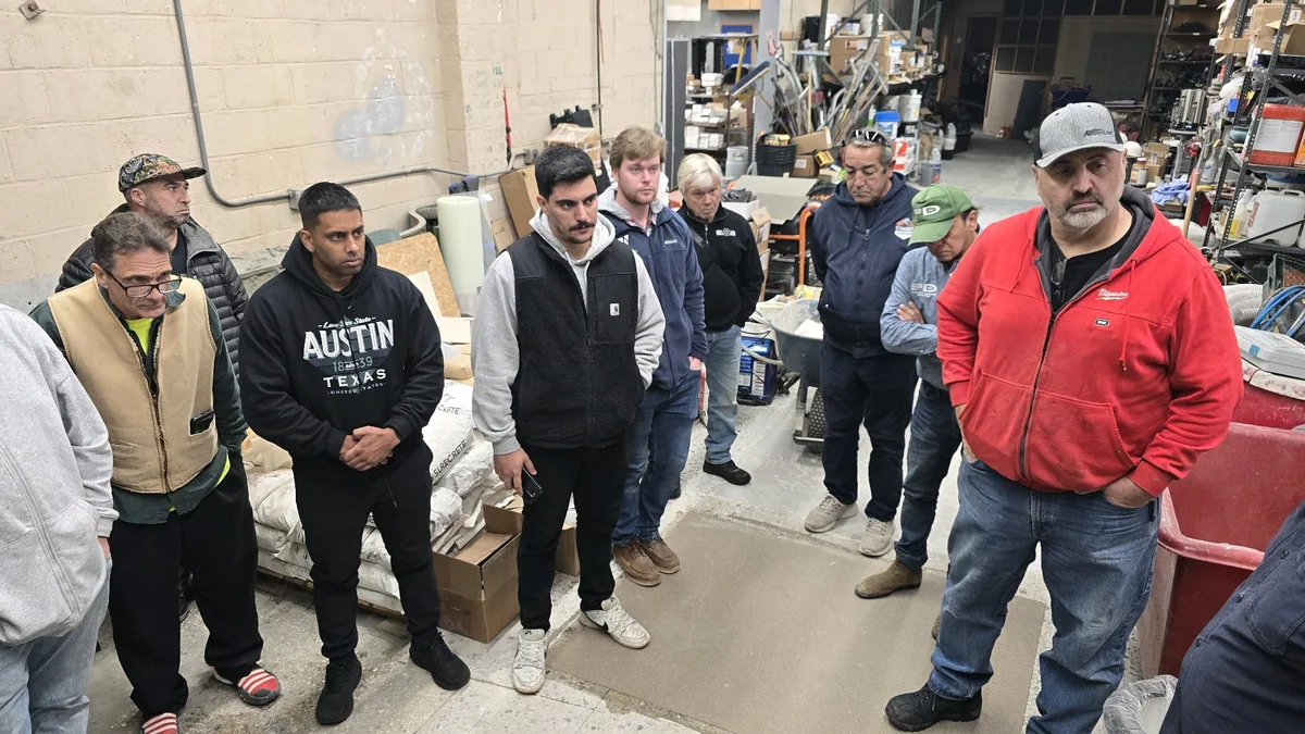 Contractors listening attentively during training demonstration